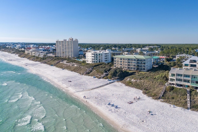 birds eye view of property with a water view, a view of the beach, and a city view