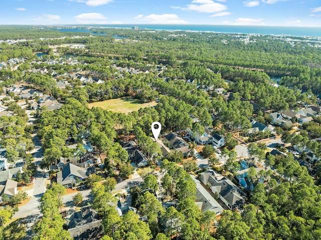 birds eye view of property featuring a wooded view and a residential view