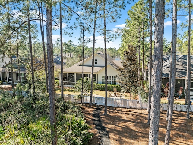 exterior space featuring a sunroom and fence