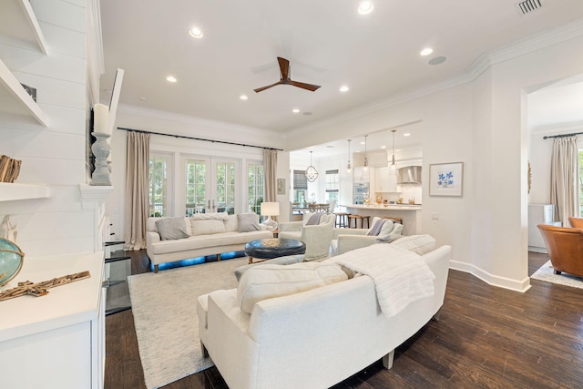 living room featuring crown molding, a healthy amount of sunlight, dark wood finished floors, and ceiling fan