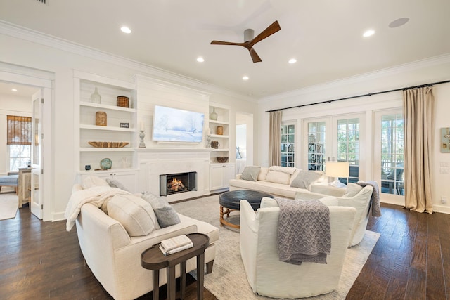 living room featuring crown molding, dark wood finished floors, a wealth of natural light, and french doors