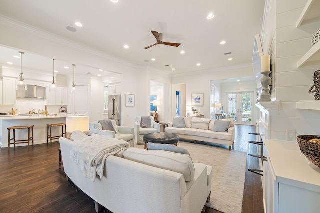 living area featuring a ceiling fan, recessed lighting, dark wood-style flooring, and ornamental molding