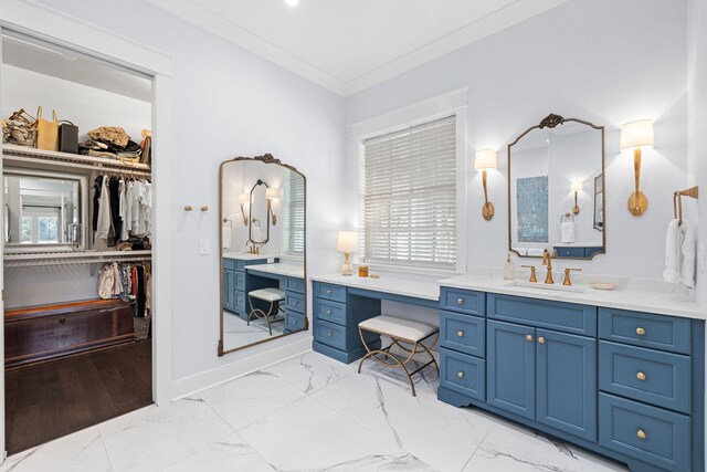 full bath featuring marble finish floor, a spacious closet, ornamental molding, and vanity