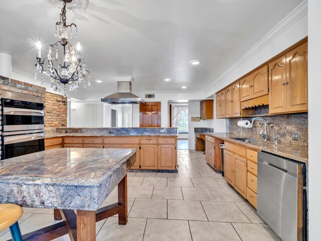 kitchen with a sink, stainless steel appliances, crown molding, tasteful backsplash, and island range hood