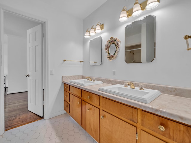 bathroom with tile patterned flooring, double vanity, and a sink