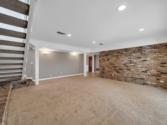interior space with visible vents, brick wall, stairs, carpet flooring, and recessed lighting