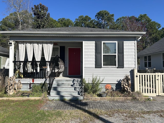 bungalow-style house featuring fence and a porch