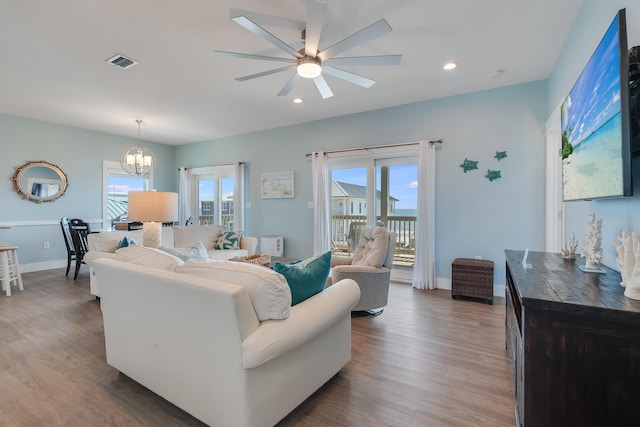 3625 Cape San Blas Rd, Cape San Blas, FL 32456 - living area featuring a wealth of natural light, visible vents, ceiling fan with notable chandelier, and wood finished floors