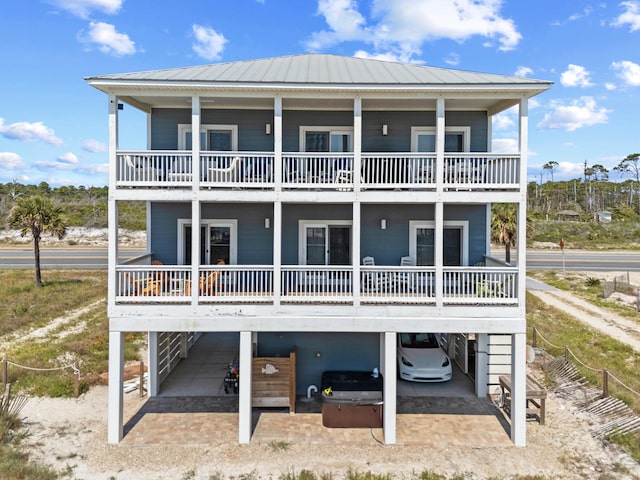 3625 Cape San Blas Rd, Cape San Blas, FL 32456 - rear view of house featuring a carport, a porch, and metal roof