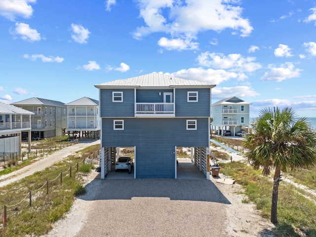 3625 Cape San Blas Rd, Cape San Blas, FL 32456 - back of property featuring metal roof, a balcony, a carport, driveway, and a standing seam roof
