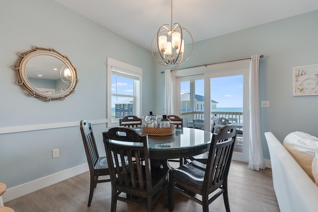 3625 Cape San Blas Rd, Cape San Blas, FL 32456 - dining room featuring a notable chandelier, baseboards, and light wood-type flooring