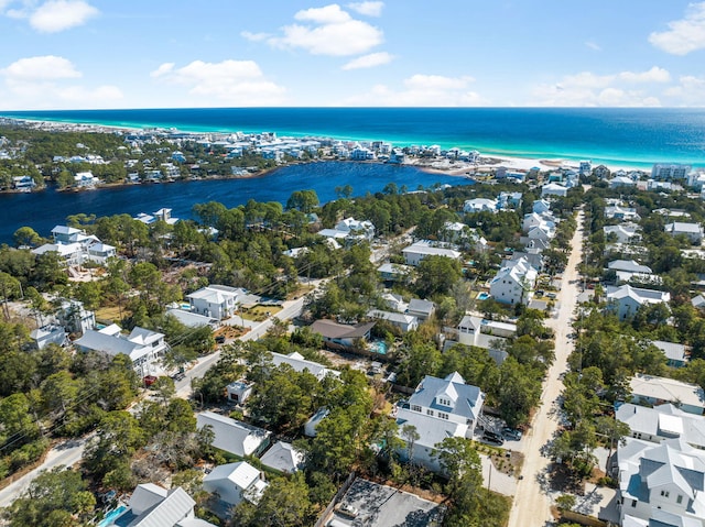 birds eye view of property featuring a water view, a residential view, and a view of the beach