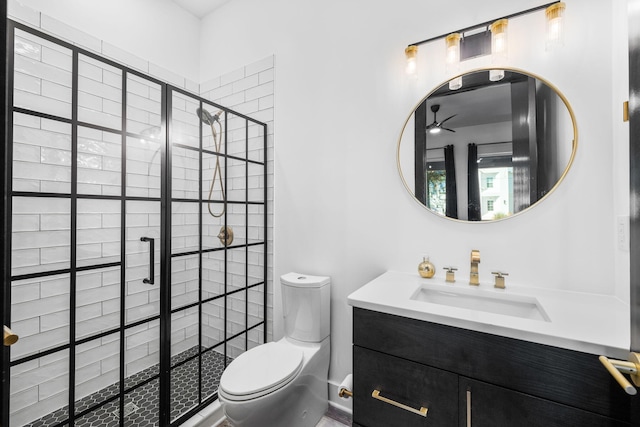 full bath with a stall shower, vanity, and toilet