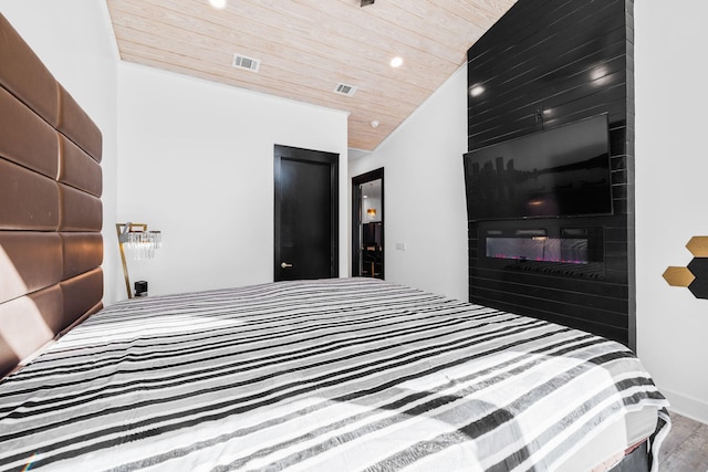 bedroom featuring a fireplace, recessed lighting, visible vents, wood ceiling, and vaulted ceiling