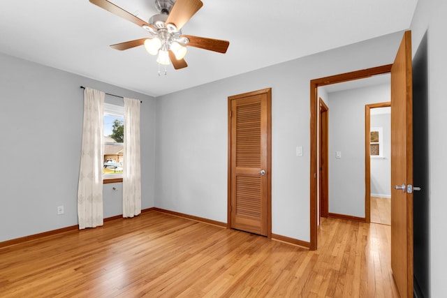 unfurnished bedroom featuring light wood-style flooring, baseboards, a closet, and ceiling fan