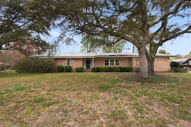 single story home featuring brick siding and a front yard