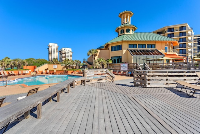 community pool with a wooden deck