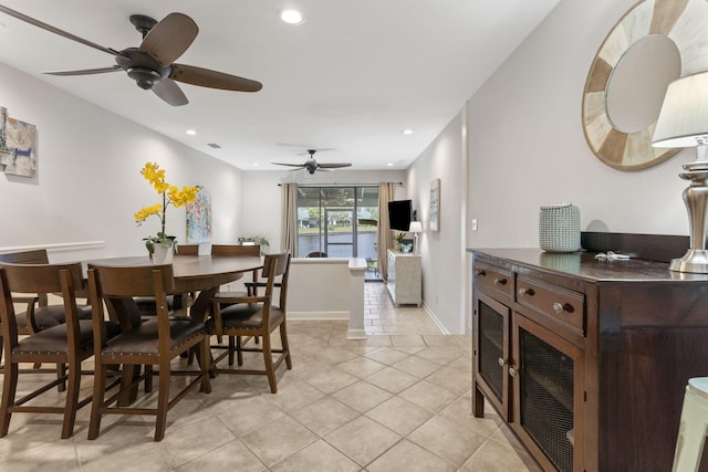 dining space featuring recessed lighting, light tile patterned flooring, and baseboards