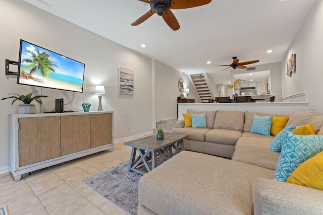 living area featuring light tile patterned floors, recessed lighting, stairway, a ceiling fan, and baseboards