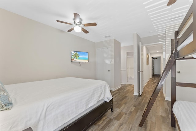 bedroom with wood finished floors, a ceiling fan, and baseboards