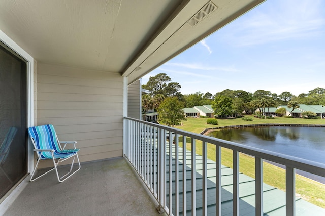 balcony with a water view and visible vents