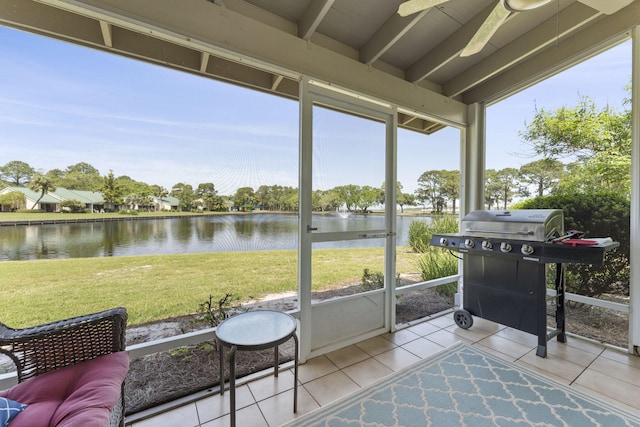 sunroom / solarium with a water view