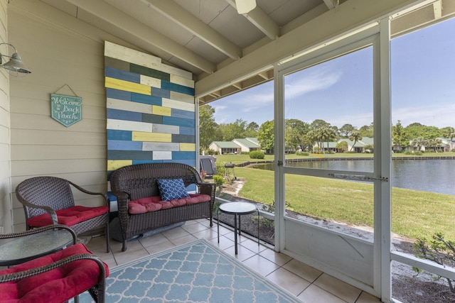 sunroom featuring vaulted ceiling with beams and a water view