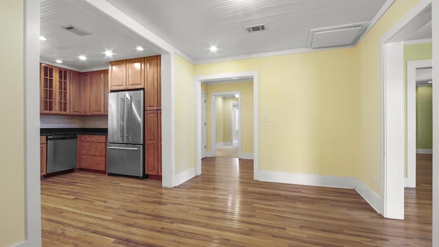 516 College Ave, Defuniak Springs, FL 32435 - kitchen with stainless steel appliances, wood finished floors, visible vents, dark countertops, and glass insert cabinets
