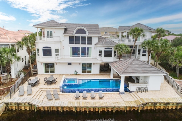 back of property with a patio, cooling unit, a fenced backyard, a balcony, and stucco siding