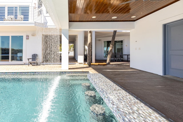 outdoor pool with a patio area