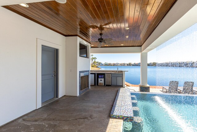 view of swimming pool with a ceiling fan, a sink, area for grilling, and a patio