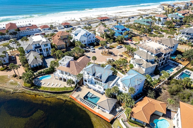 birds eye view of property with a view of the beach, a water view, and a residential view