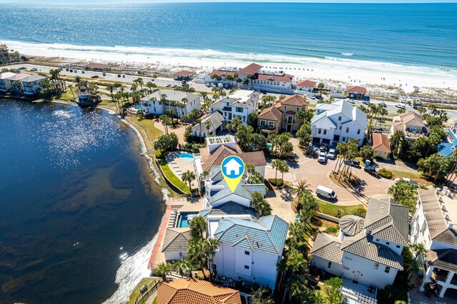 birds eye view of property with a water view, a residential view, and a view of the beach