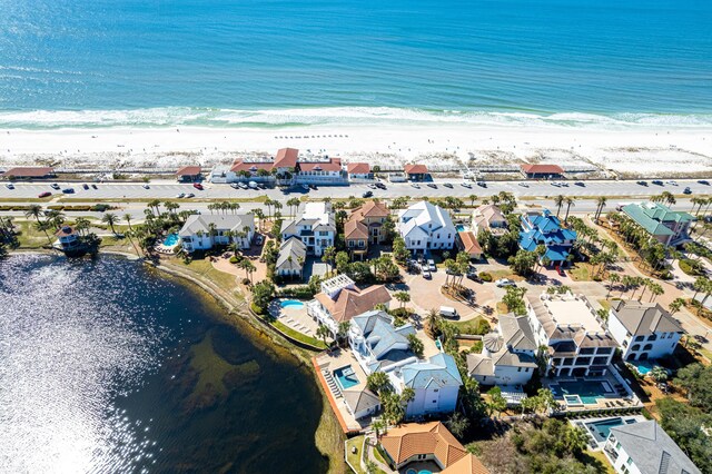 bird's eye view featuring a view of the beach, a water view, and a residential view