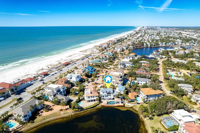 drone / aerial view with a water view and a view of the beach