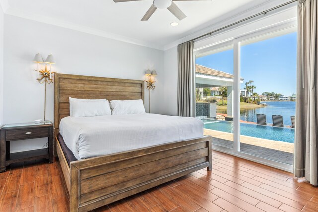 bedroom featuring a water view, ornamental molding, ceiling fan, wood finished floors, and access to outside