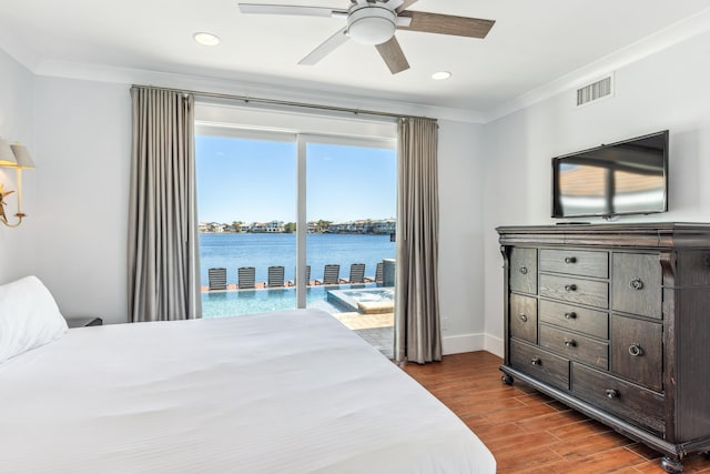 bedroom with baseboards, visible vents, dark wood finished floors, ornamental molding, and access to exterior