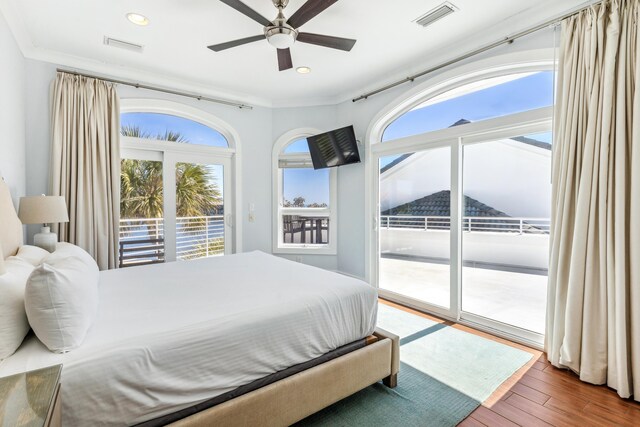 bedroom featuring access to outside, multiple windows, visible vents, and wood finished floors