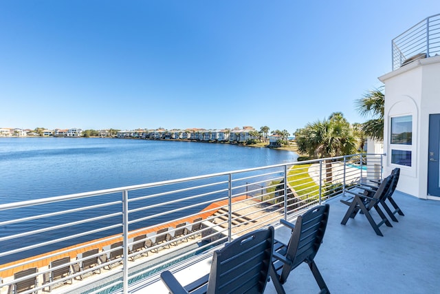 view of patio / terrace featuring a water view and a balcony