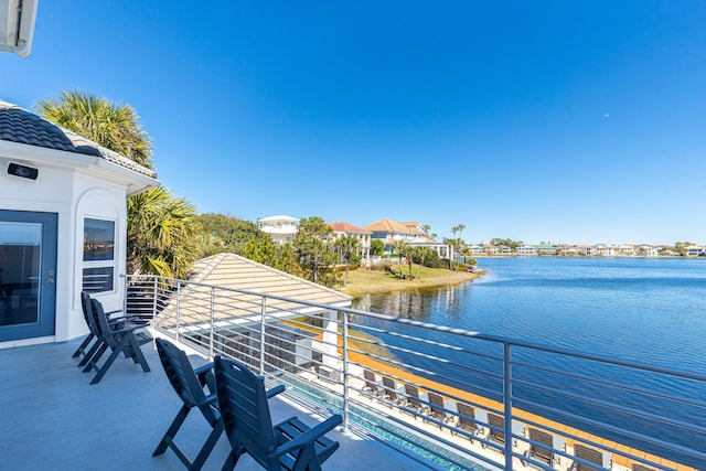 view of dock featuring a water view and a balcony