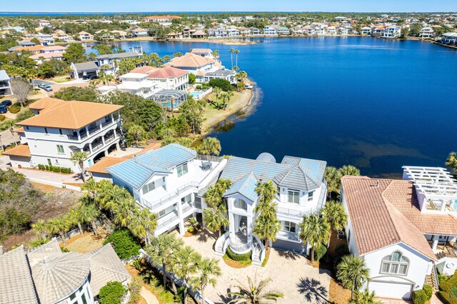 drone / aerial view featuring a residential view and a water view