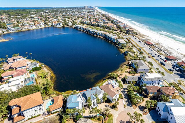 bird's eye view featuring a view of the beach, a residential view, and a water view