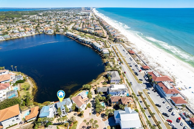 birds eye view of property with a water view and a beach view