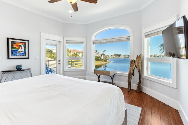 bedroom with crown molding, multiple windows, dark wood finished floors, and access to exterior