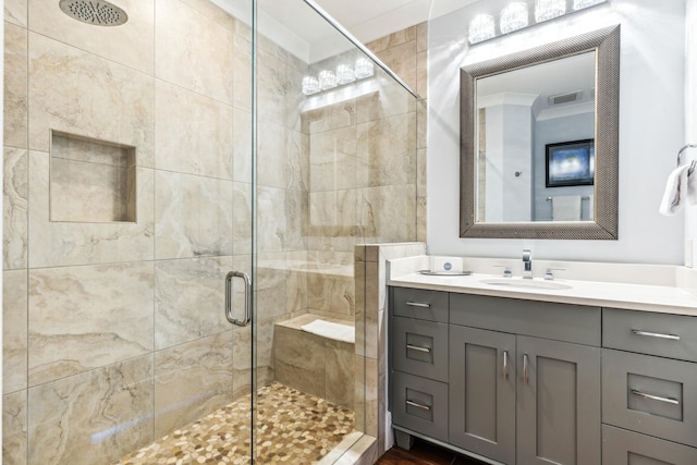 full bathroom featuring a stall shower, visible vents, crown molding, and vanity