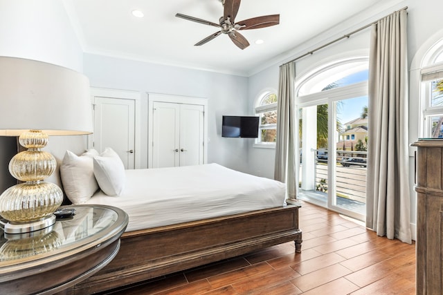 bedroom featuring access to exterior, ornamental molding, wood finished floors, and recessed lighting