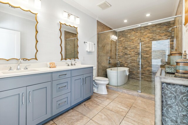 full bathroom with double vanity, tiled shower, and a sink