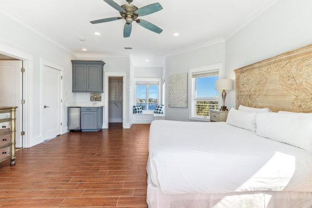 bedroom featuring ornamental molding, recessed lighting, baseboards, and wood finished floors