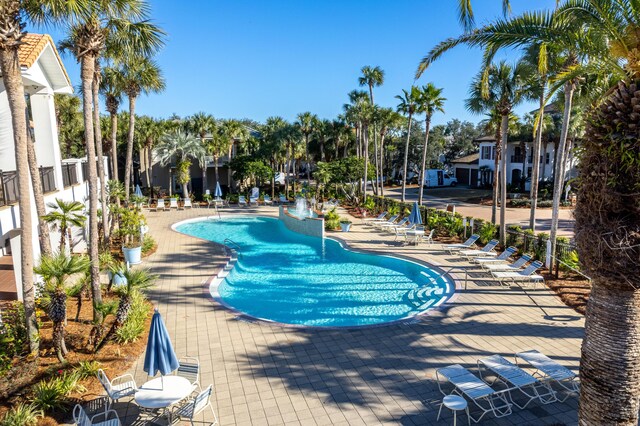 view of swimming pool featuring fence and a patio