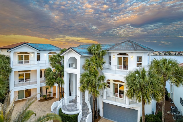 4659 Destiny Way, Destin, FL 32541 - view of front facade featuring a balcony, central AC, stucco siding, a garage, and a tile roof